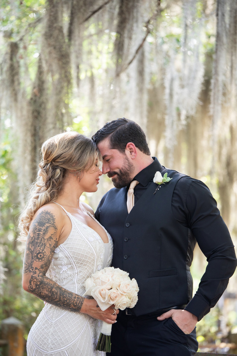 Tattoed bride and groom in a black suit had an elopement in Bonaventure Cemetery