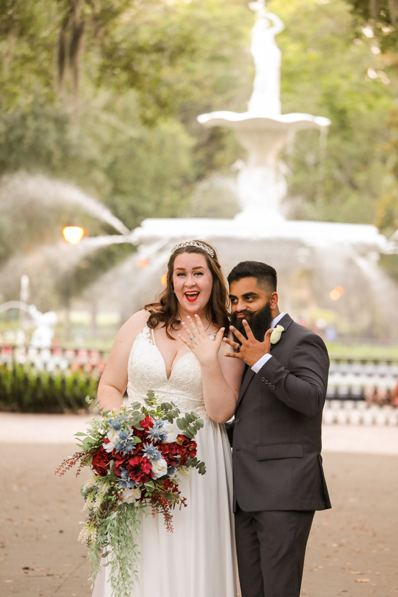 Forsyth fountain in Savannah with happy couple showing off their rings