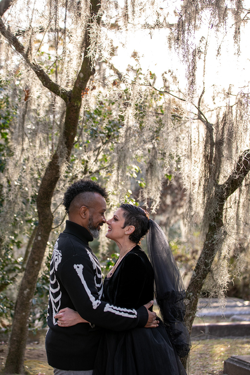 Elopement photo in Bonaventure Cemetery with an interracial couple wearing black.